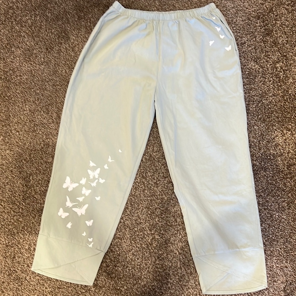 Light sage green capris pants w/butterflies on 1 leg and on 1 side of the waist.